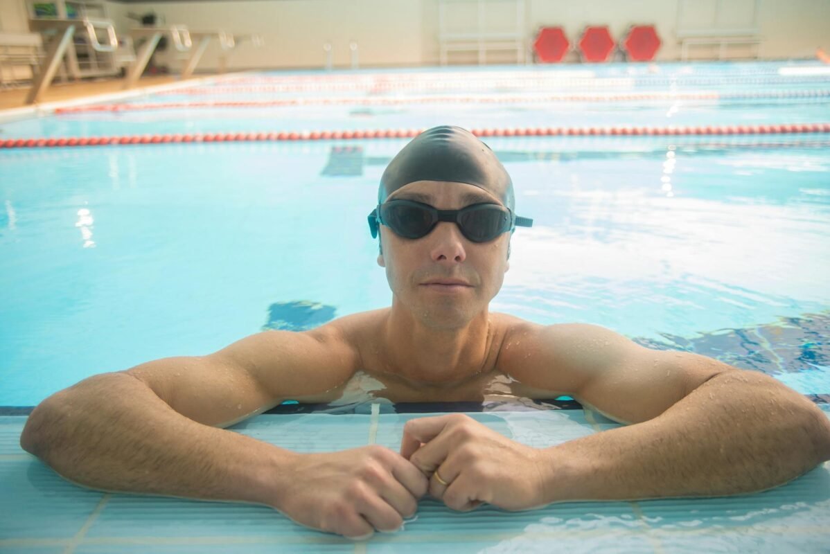 Male swimmer wearing goggles during pool training
