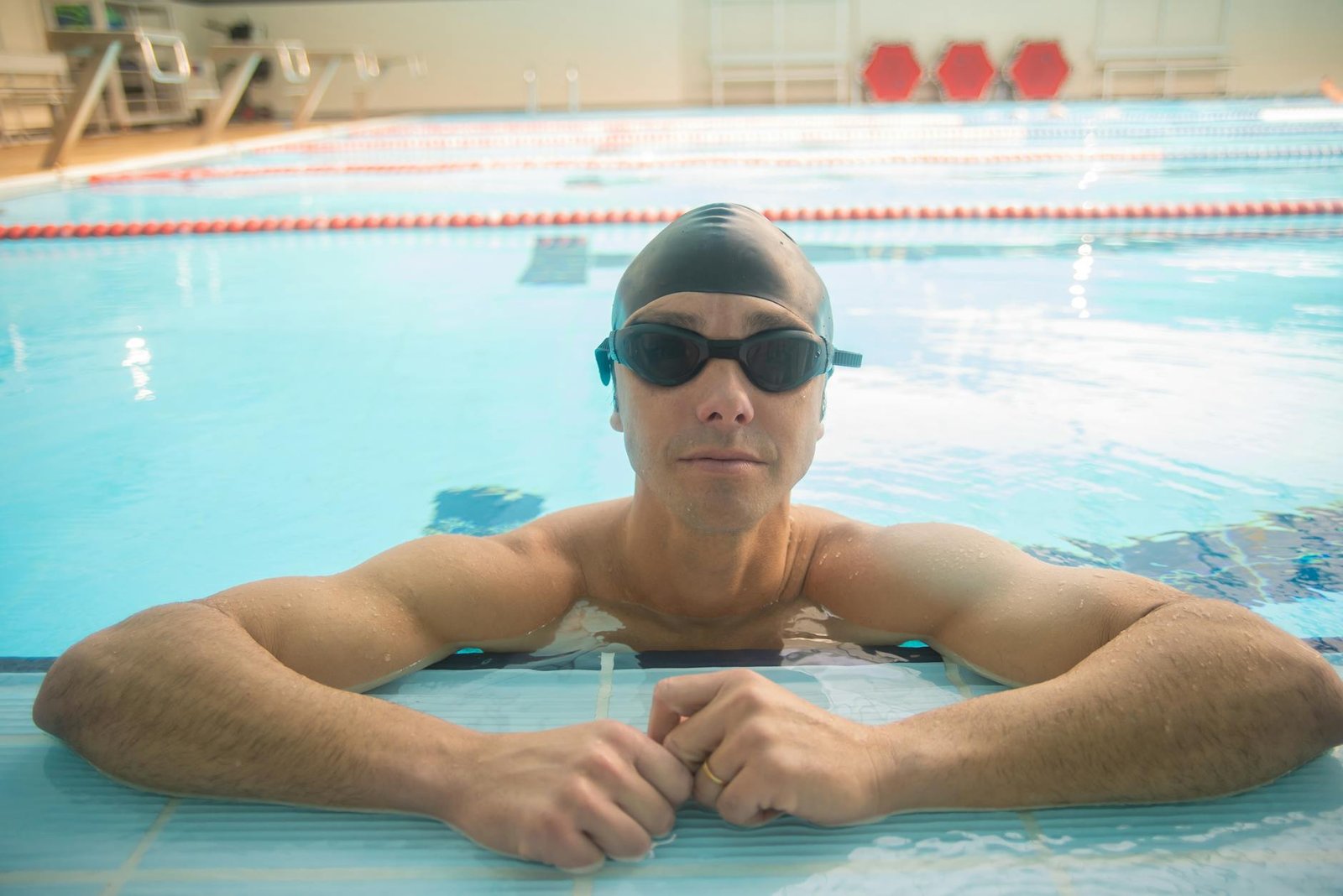 Male swimmer wearing goggles during pool training