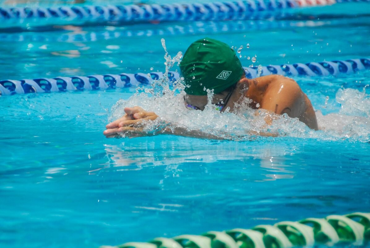Freestyle swimmer wearing low-profile racing goggles in the pool