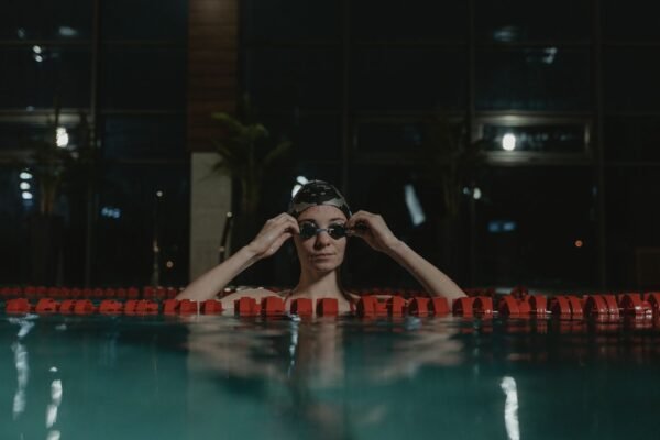 Woman swimmer wearing swim goggles during pool training