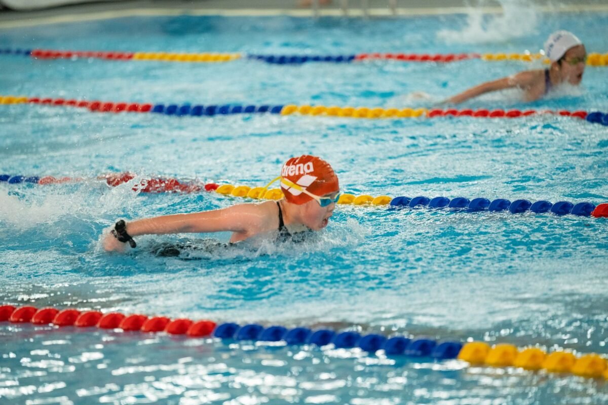 Swimmer using a swim watch at the pool for lap tracking