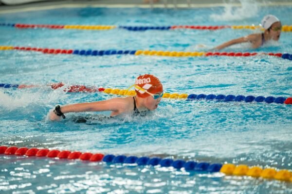 Swimmer using a swim watch at the pool for lap tracking