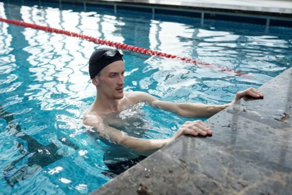 Swimmer doing dryland core exercises on a training mat