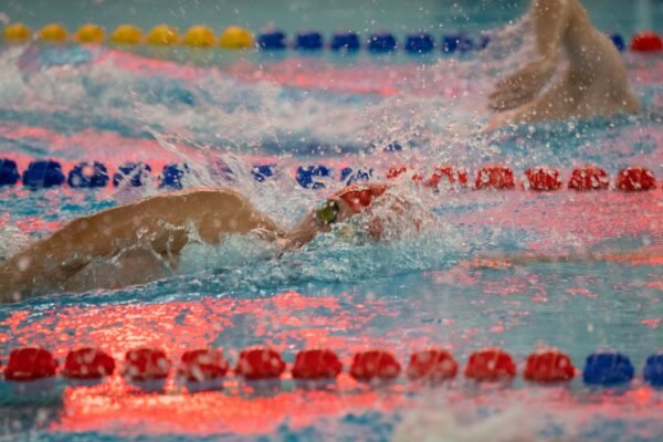 Freestyle swimmer wearing low-profile racing goggles in the pool
