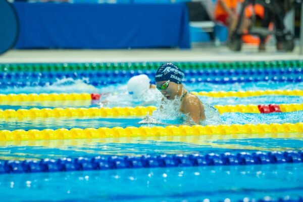 Swimmer training individual medley in a pool