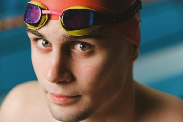 Swimmer wearing clear anti-fog swim goggles in a pool