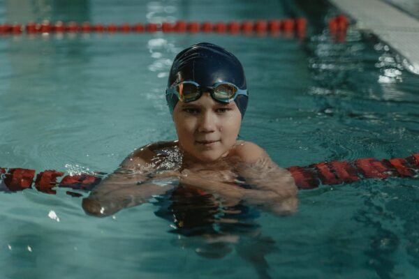 Junior swimmer wearing swim goggles during pool training
