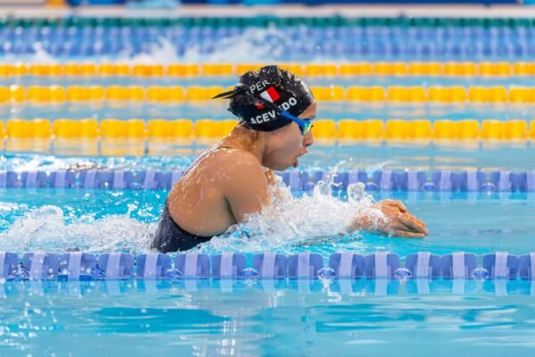 Swimmer practicing freestyle breathing technique in a pool