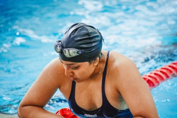 Competitive swimmer adjusting goggles before a swim race