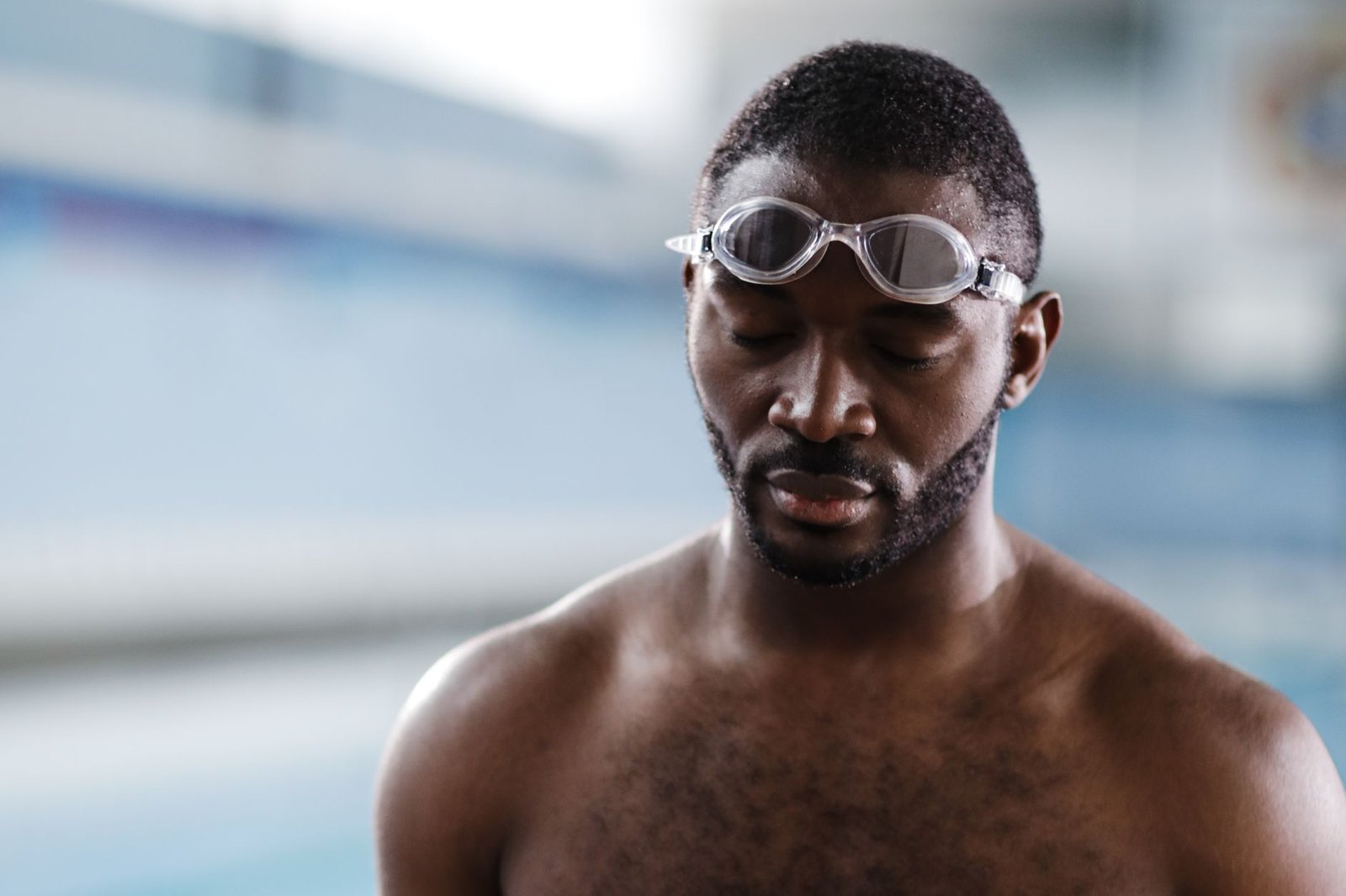 Swimmer adjusting swim goggles before entering the pool